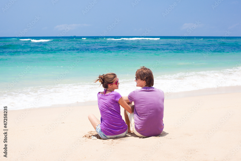 young beautiful couple on tropical bali beach.honeymoon