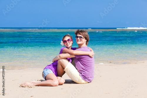 young beautiful couple on tropical bali beach.honeymoon