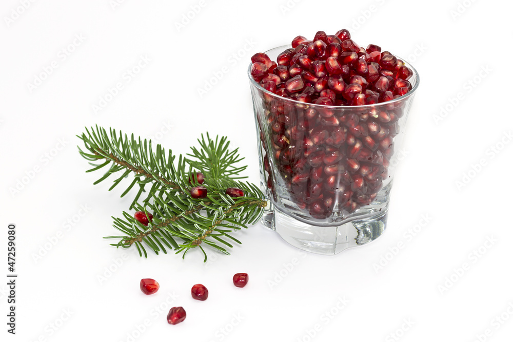 Glass of pomegranate with twig spruce Glass of pomegranate with twig spruce