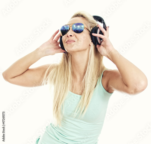 Young woman listening music in headphones. Isolated on white.
