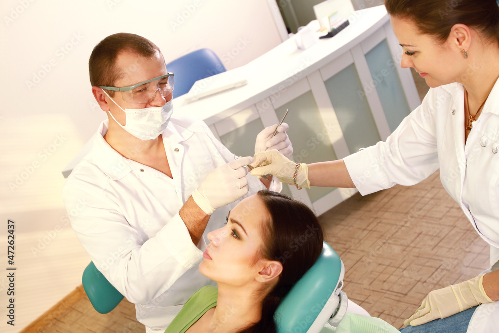 Young woman with dentist in a dental surgery Young woman with dentist in a dental surgery