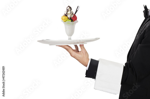 young waiter in work uniformon with ice cream photo