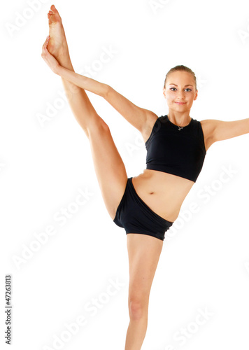 Young woman in black practicing yoga