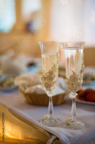 champagne glasses standing on a table at a wedding reception