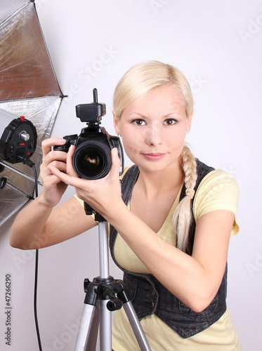young beautiful photographer with the professional camera