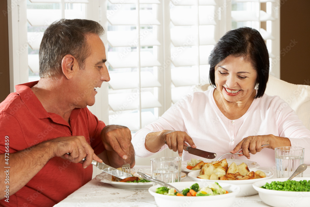 Senior Couple Enjoying Meal At Home