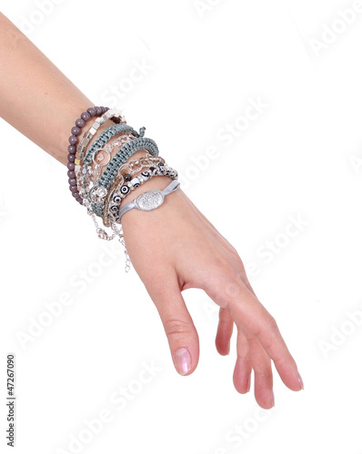 collection of bracelets on woman hand isolated