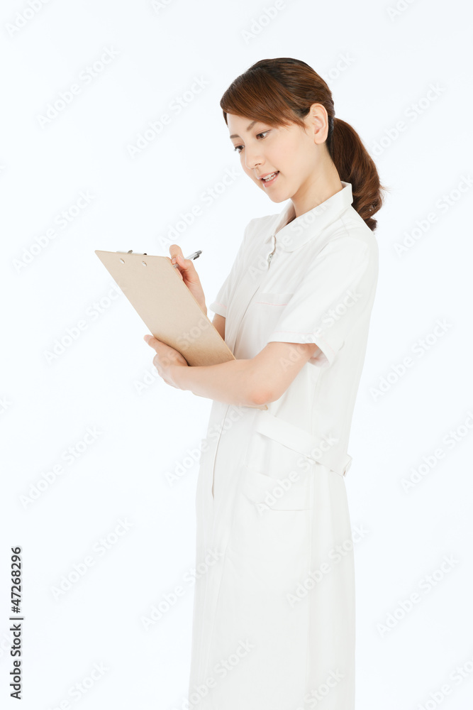 Beautiful young nurse on white background