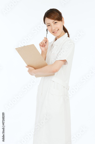 Beautiful young nurse on white background