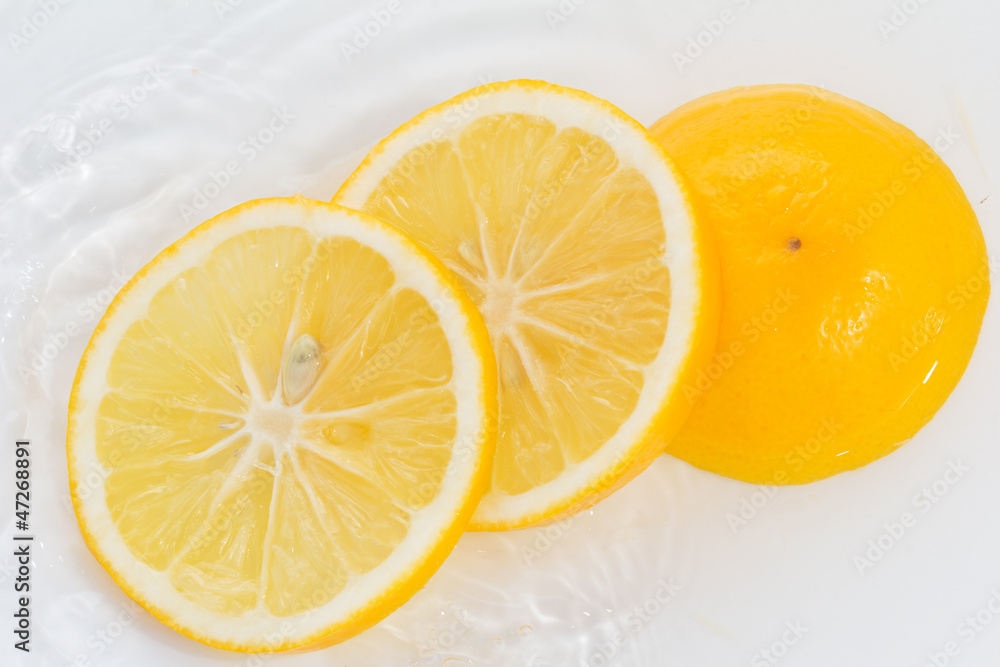 lemon in water on a white background lemon in water on a white background