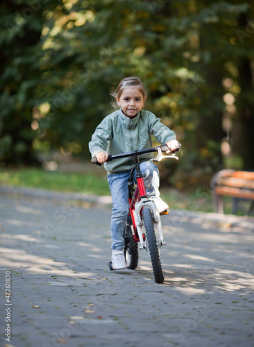 Fototapeta Naklejka Na Ścianę i Meble -  Little girl riding bike