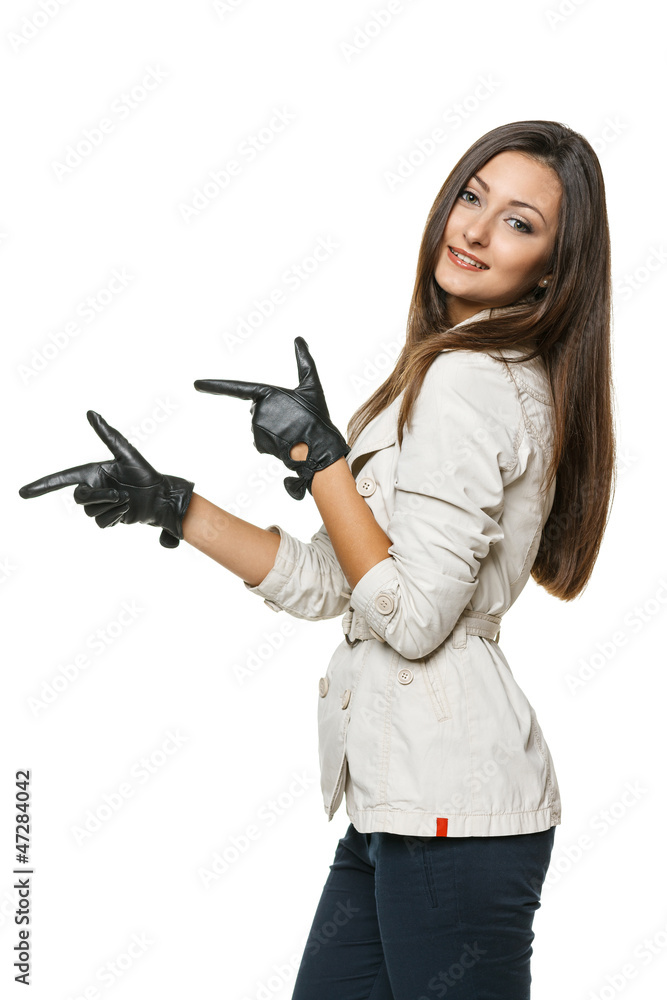 Woman in gloves pointing with both hands to the side Woman in gloves pointing with both hands to the side