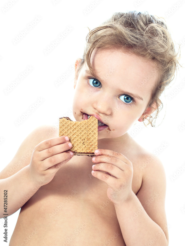 Beautiful sweet little girl eating a cookie Beautiful sweet little girl eating a cookie