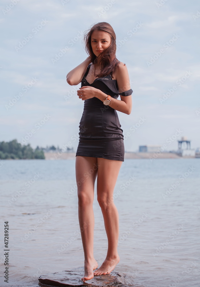 Beautiful young woman near the water Beautiful young woman near the water