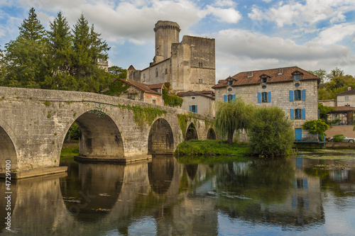 Bridge with Bourdeilles French castle in background © Christian Delbert