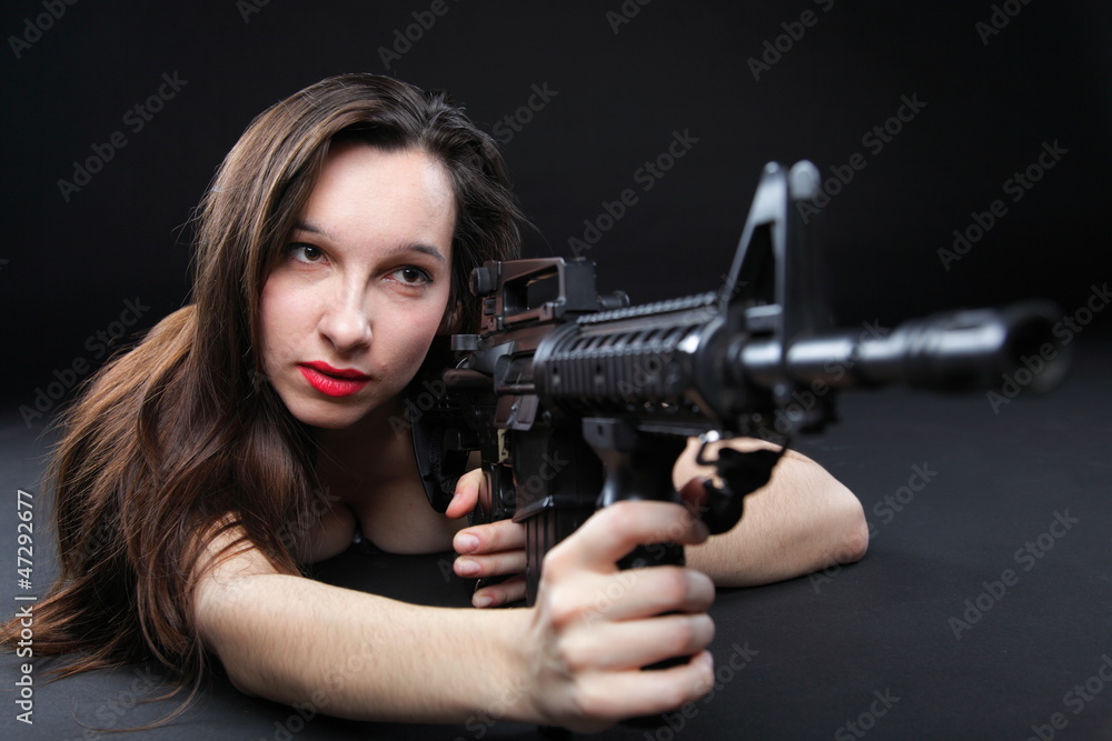 Girl holding Rifle on black background Girl holding Rifle on black background
