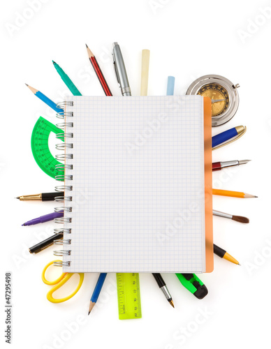 school supplies and checked notebook on white