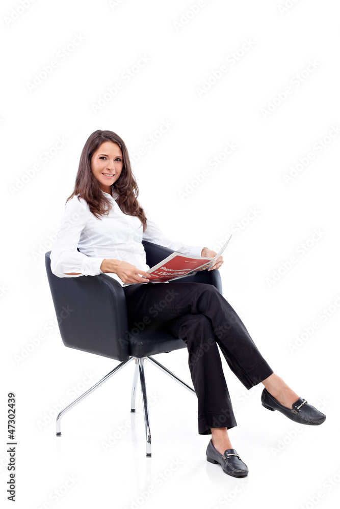Casual 20s women sitting with newspaper Casual 20s women sitting with newspaper