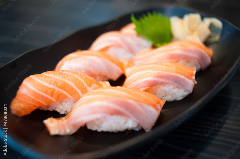 Close up of Salmon Sushi Set on Black Dish Close up of Salmon Sushi Set on Black Dish