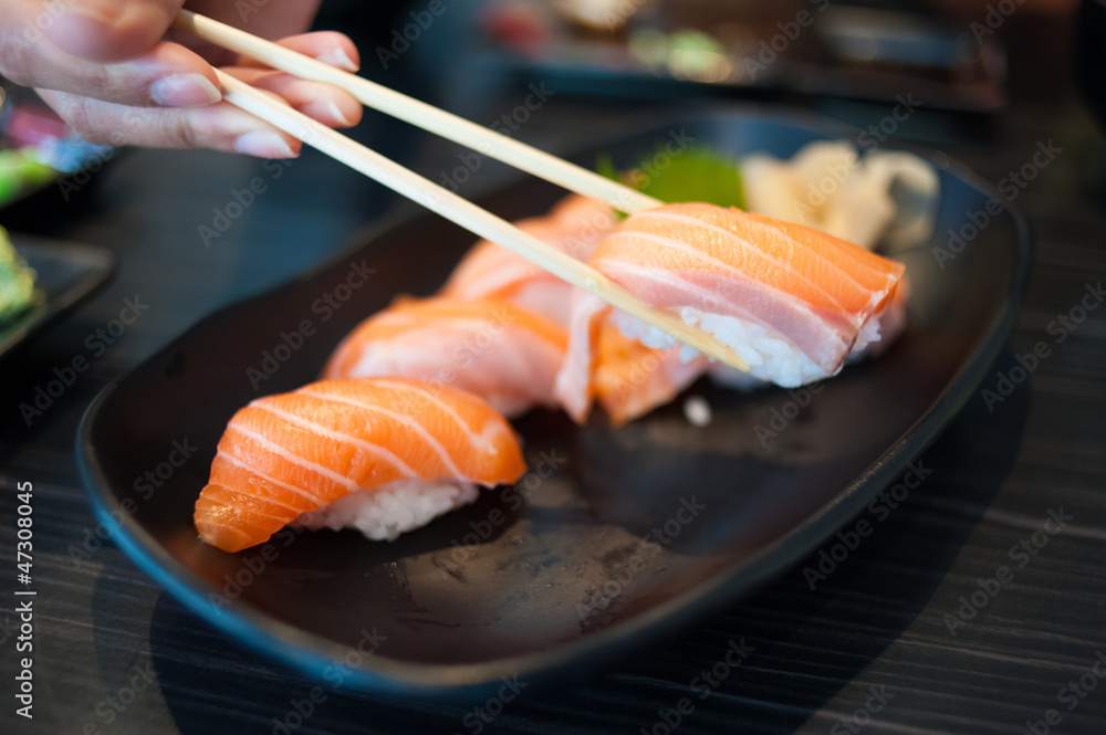 Close up of Salmon Sushi Set on Black Dish Close up of Salmon Sushi Set on Black Dish