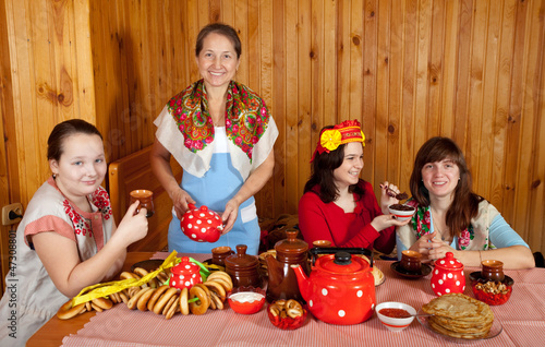 Women  drinks tea and eats pancake photo