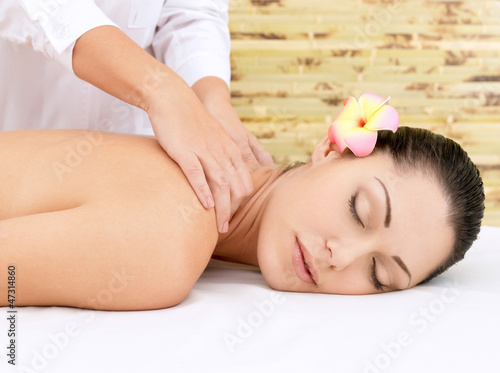 Woman having massage of head in spa salon