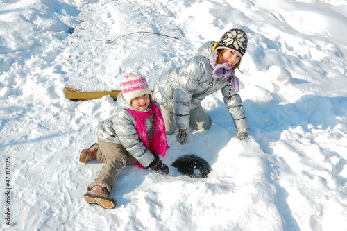 Kids having fun in winter, children playing with snow