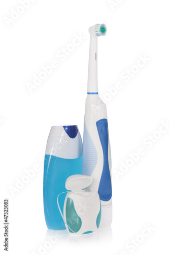 Electric toothbrush, toothpaste and dental floss isolated
