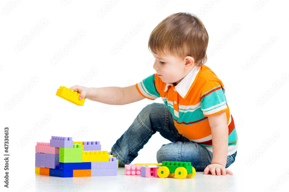 kid boy playing with construction set over white background