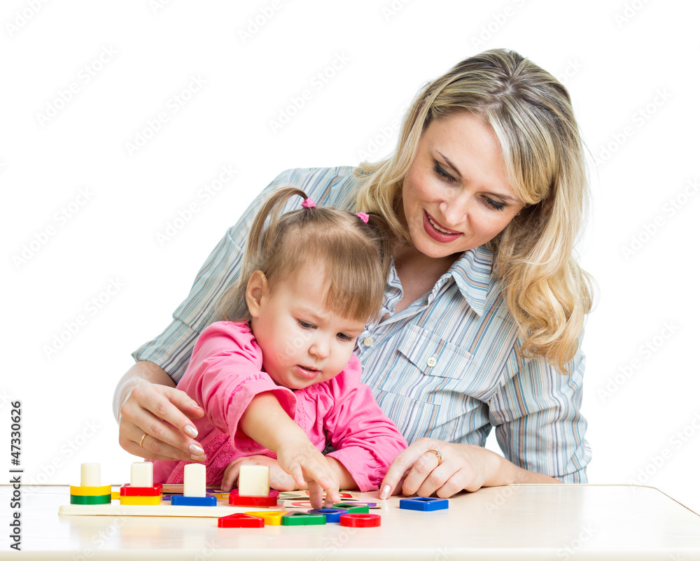mother and her child playing with colorful puzzle toy mother and her child playing with colorful puzzle toy
