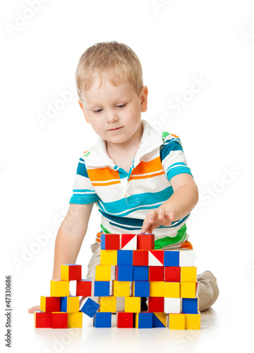 Child boy playing toy block...
