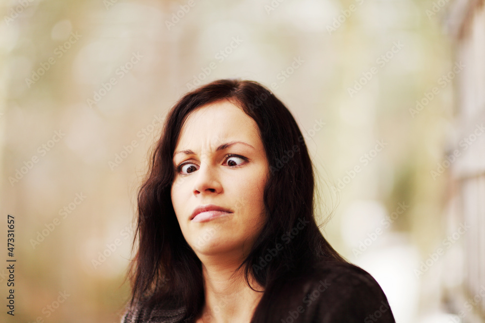 Young woman showing funny squint Young woman showing funny squint