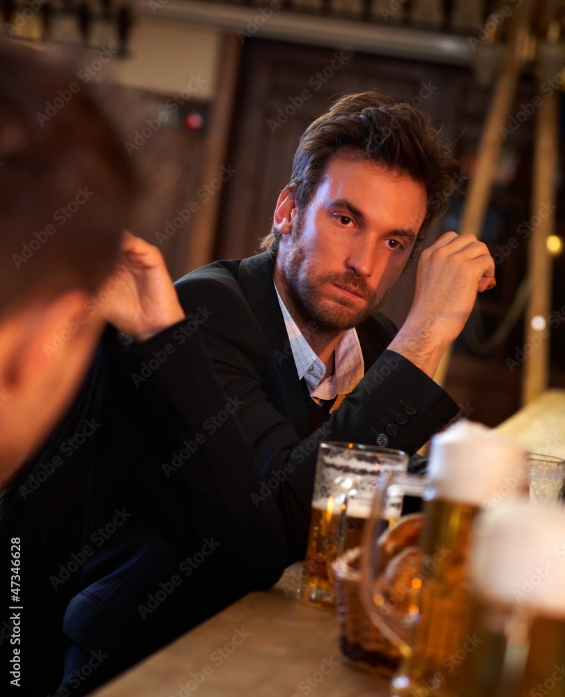 Young businessman drunk in pub
