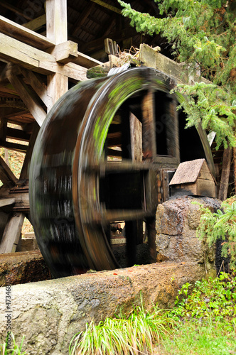 wooden wheel of an ancient water mill in motion