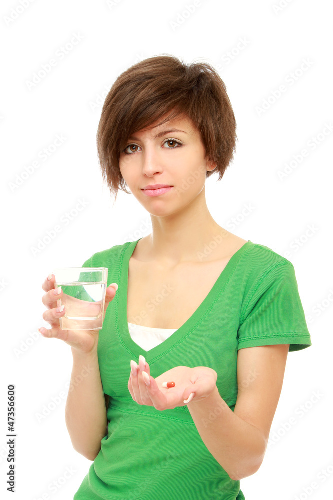 Young woman holding a pill and water, isolated on white Young woman holding a pill and water, isolated on white