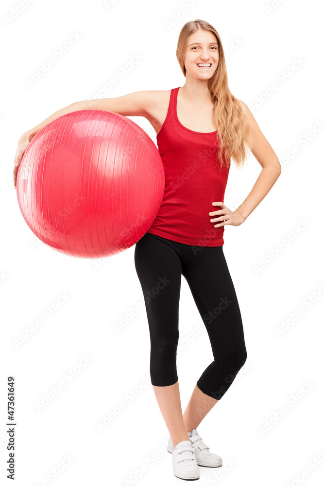 Young female athlete holding a pilates ball Young female athlete holding a pilates ball
