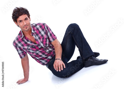 Handsome guy sitting on the floor
