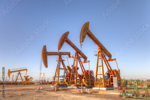 oil pump jacks under blue sky. (HDR)