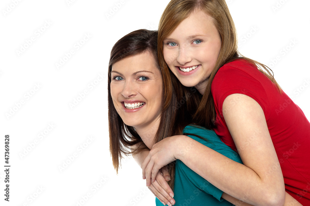 Mother giving daughter ride on back Mother giving daughter ride on back