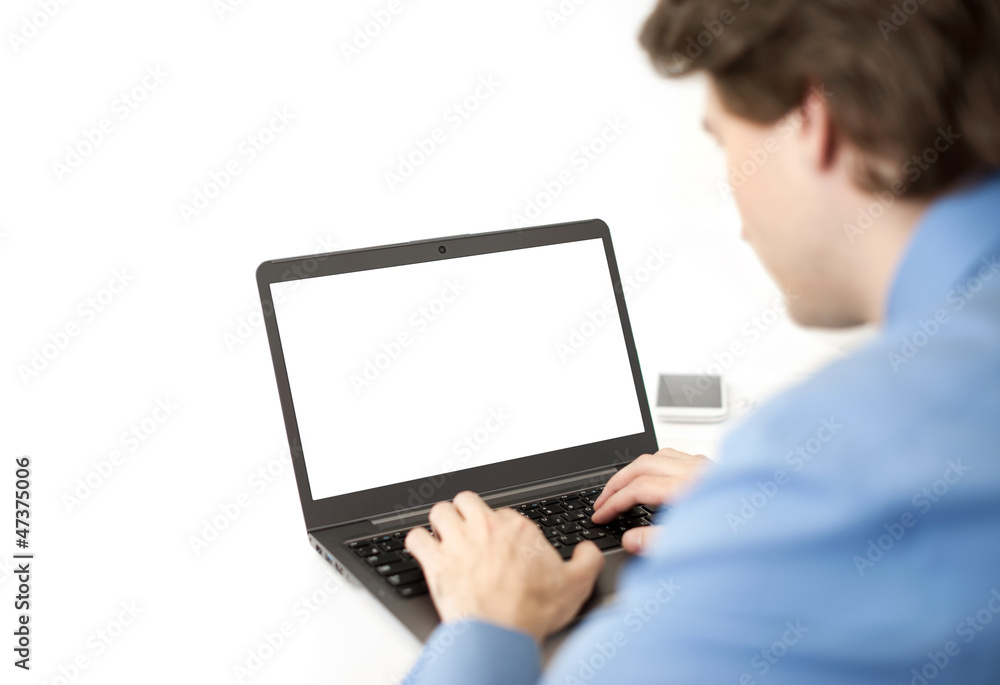 Rear view of business man sitting at office and using laptop