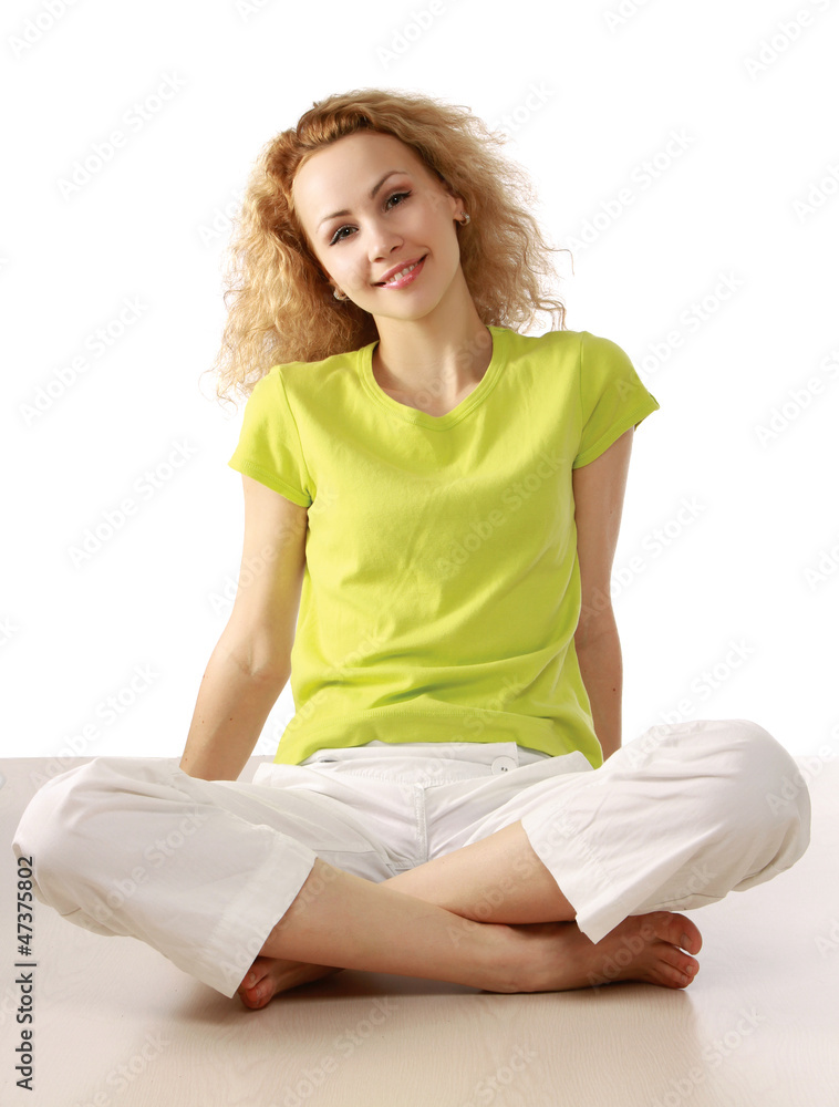 Smiling pretty woman stretching on the floor Smiling pretty woman stretching on the floor
