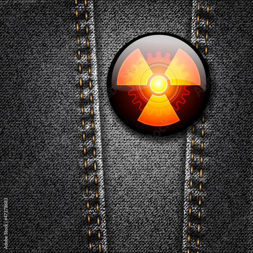Radioactivity badge on black denim texture vector