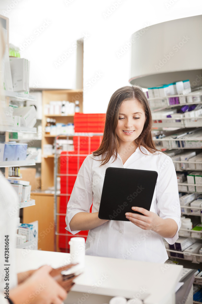 Pharmacist Helping Customer with Digital Tablet