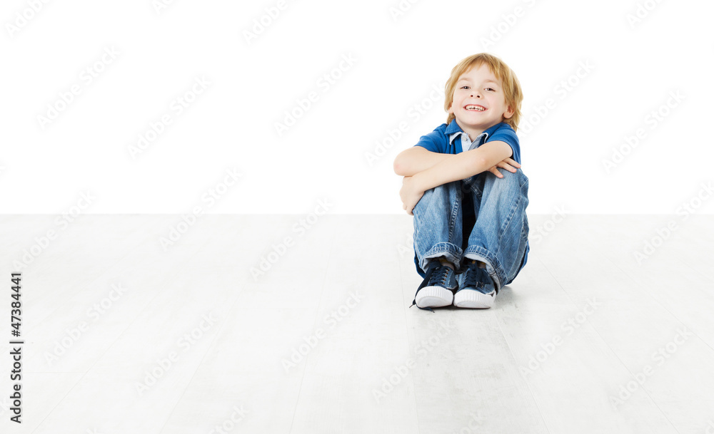 Smiling child sitting on white floor Smiling child sitting on white floor