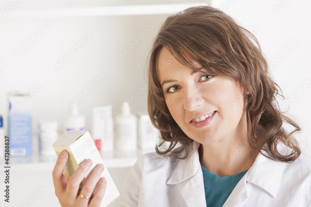 Young woman pharmacist with a bottle of drugs Young woman pharmacist with a bottle of drugs