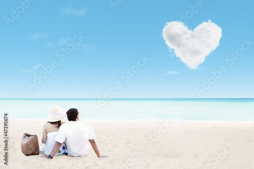 Beautiful couple geataway on beach and love cloud