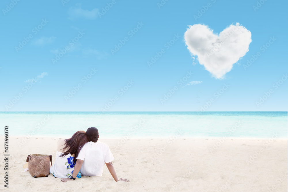 Enjoying honeymoon at white sand beach with love cloud