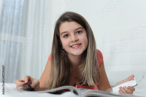little girl turning over the pages of magazines