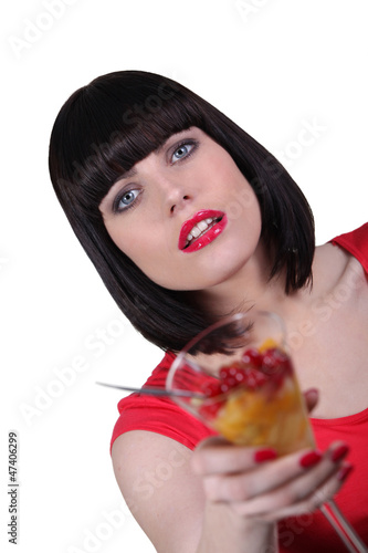 woman with cup of fruits