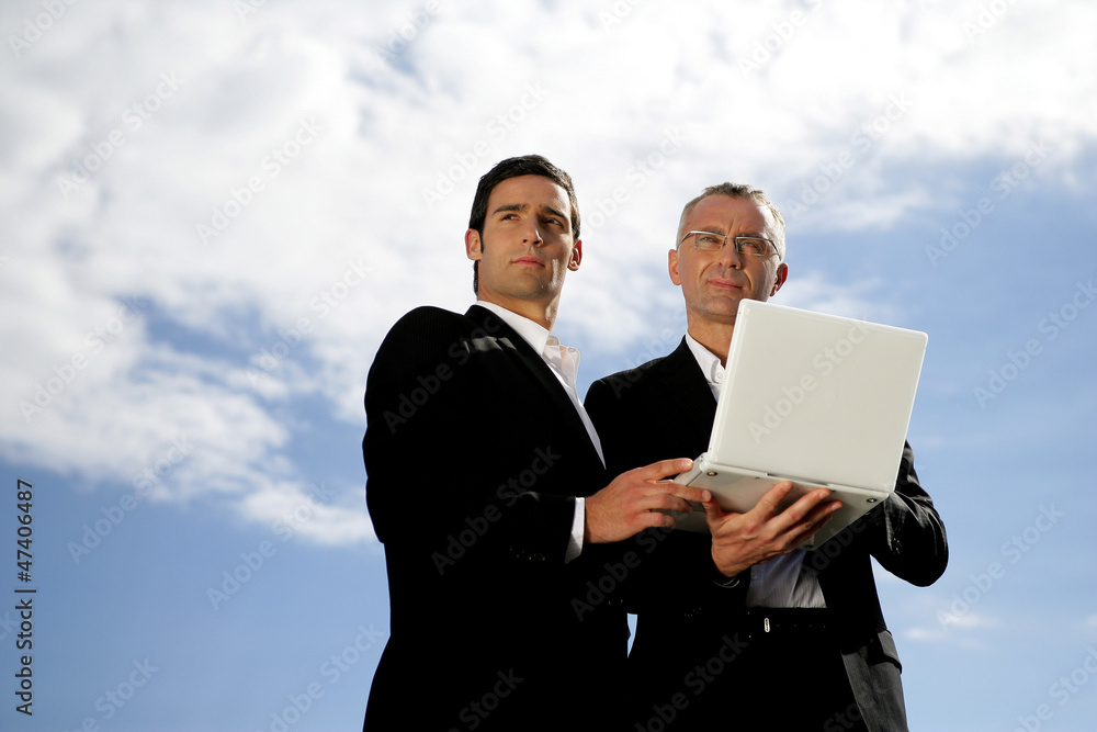 Men in suit with a laptop computer